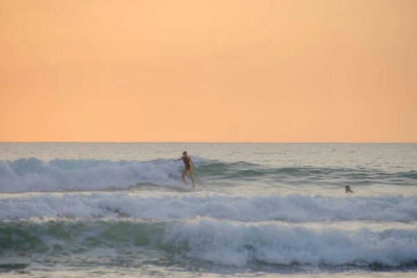 woman surfing gracefully during a women surf experience in Las Tunas, Ecuador
