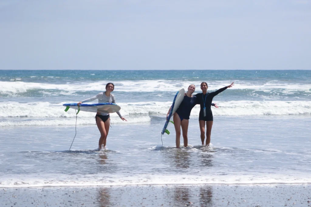 Women learning to surf in Ecuador during a women’s surf experience