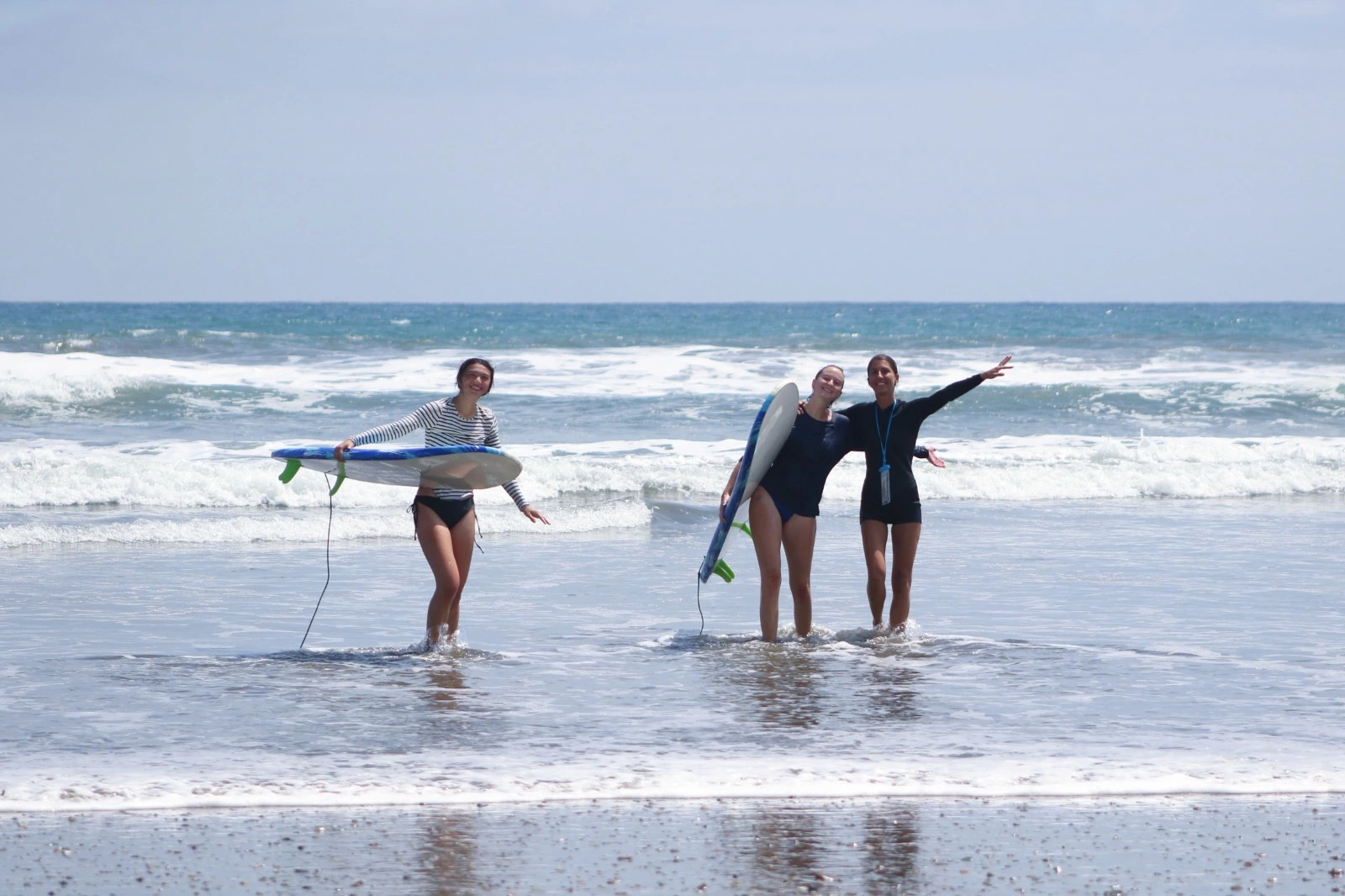 Women learning to surf in Ecuador during a women’s surf experience