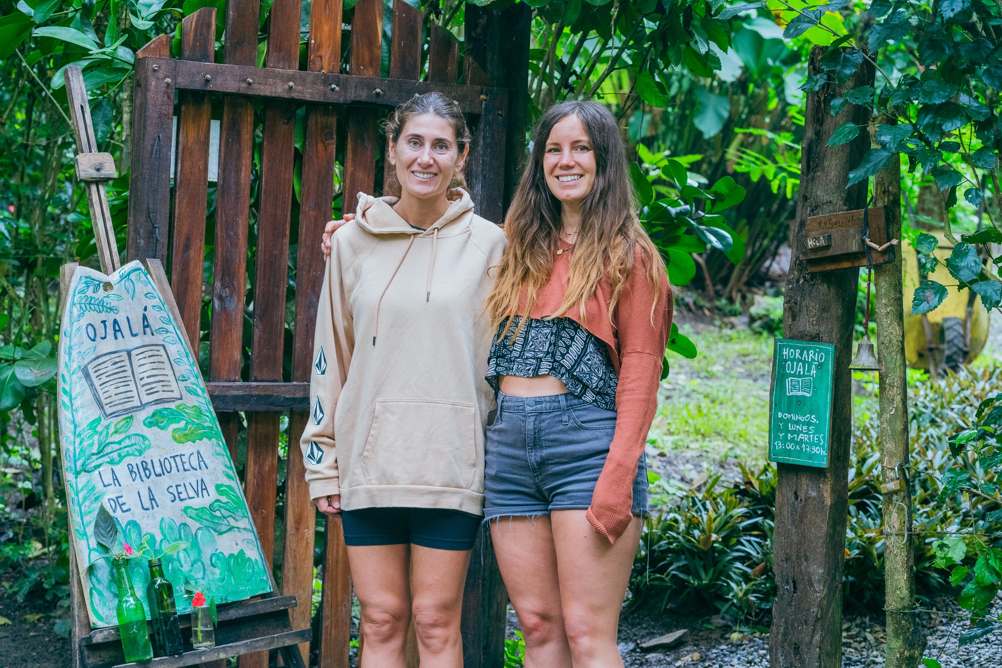 two women in a jungle library during a surf adventure in Ecuador
